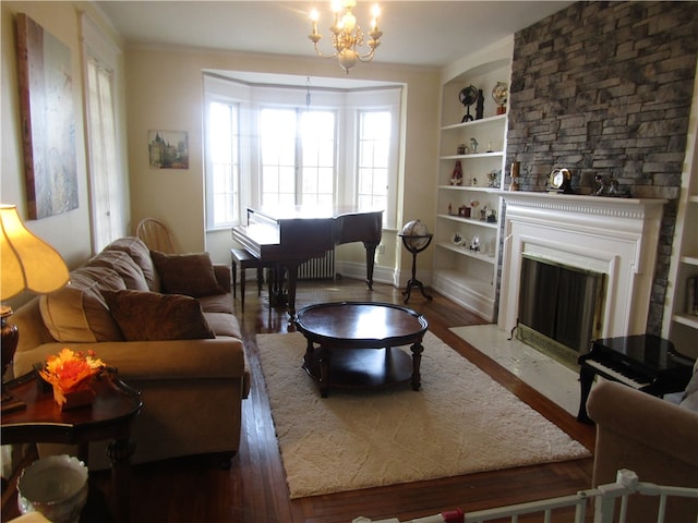 living room featuring dark hardwood / wood-style flooring, built in features, and an inviting chandelier