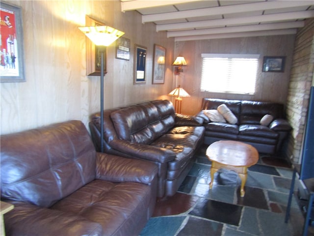 living room with wooden walls and beam ceiling