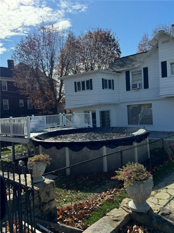 back of house featuring a deck