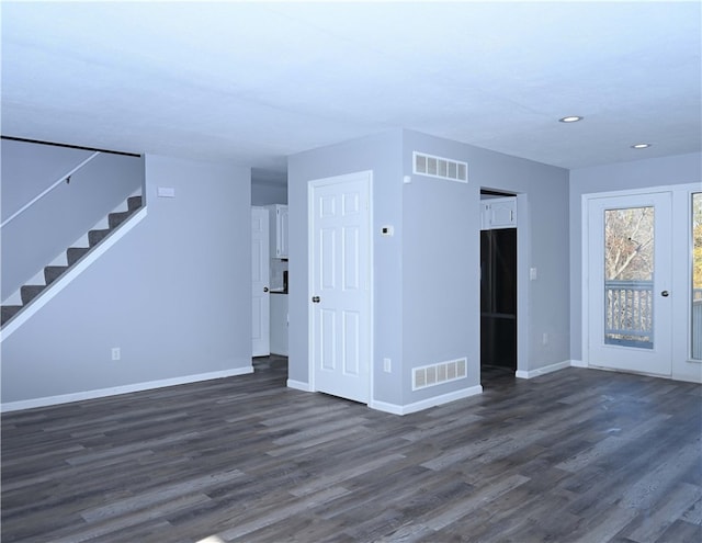 unfurnished living room featuring dark hardwood / wood-style flooring