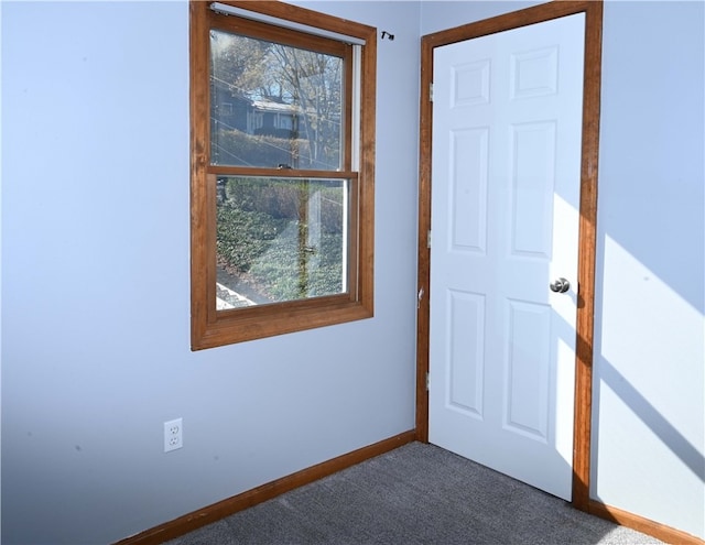 entryway featuring dark colored carpet