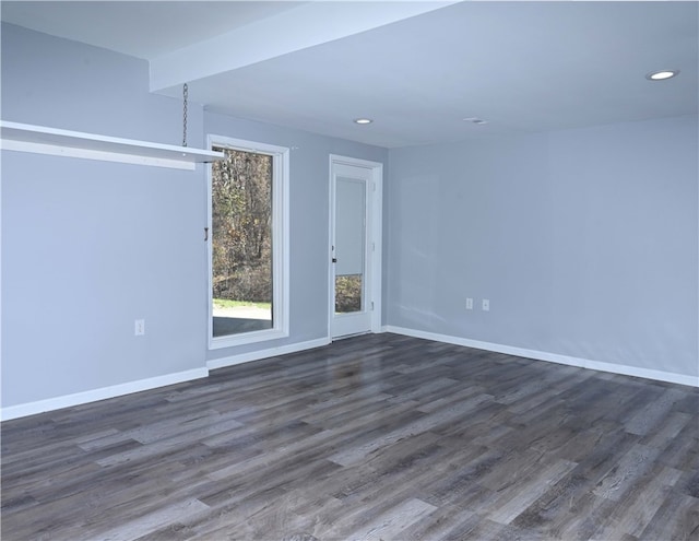 spare room featuring dark wood-type flooring