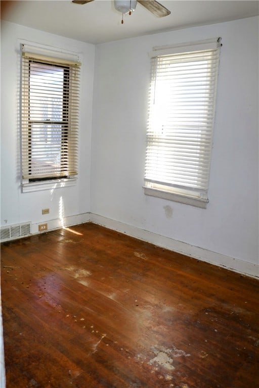 unfurnished room with ceiling fan and dark hardwood / wood-style flooring