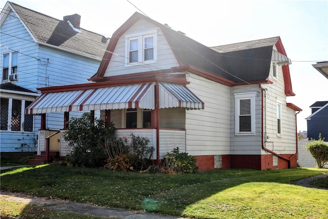 view of side of home featuring a lawn