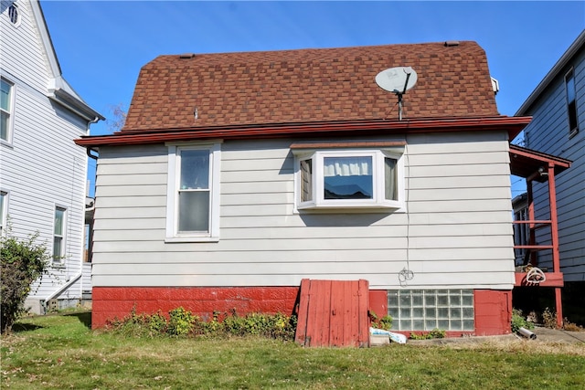 view of side of property with a lawn