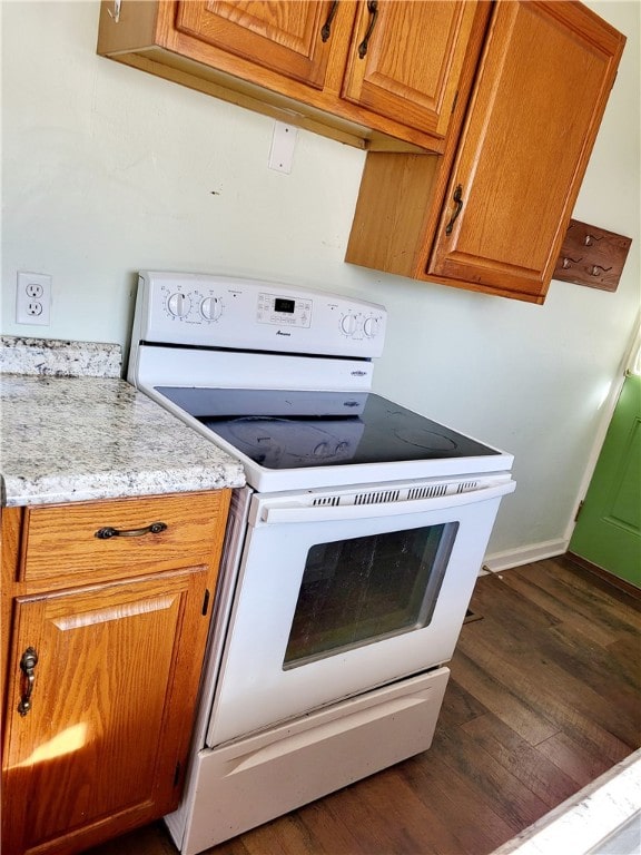 kitchen featuring white electric stove and dark hardwood / wood-style flooring