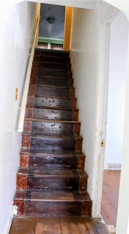 stairs with hardwood / wood-style flooring