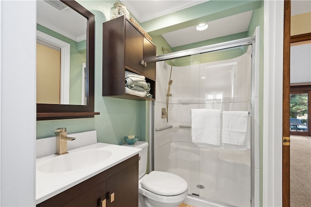 bathroom featuring toilet, ornamental molding, vanity, and walk in shower