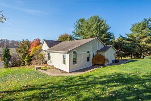 view of home's exterior with a lawn