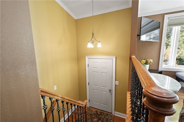 foyer entrance featuring an inviting chandelier and ornamental molding