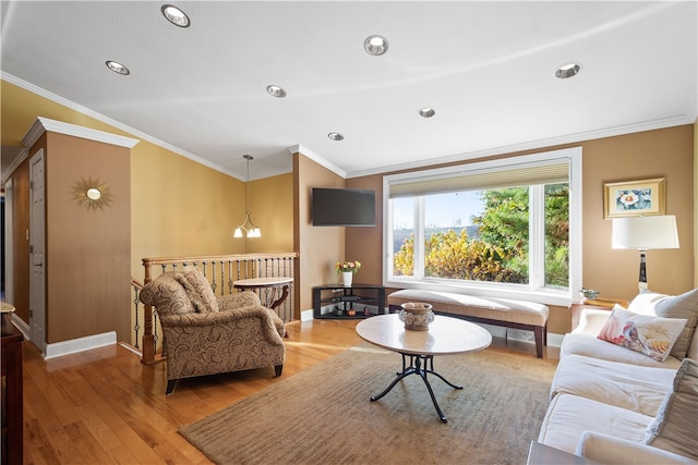 living room featuring hardwood / wood-style floors, a notable chandelier, and ornamental molding