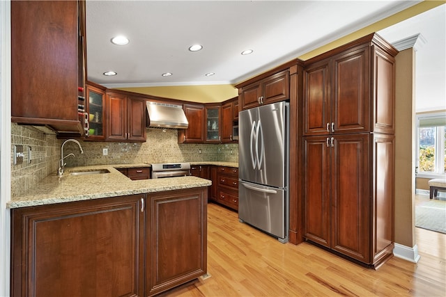 kitchen with stainless steel appliances, sink, light hardwood / wood-style flooring, crown molding, and wall chimney range hood