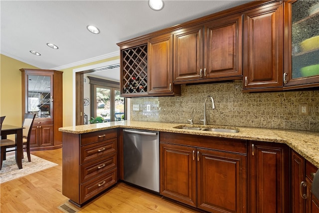 kitchen featuring sink, ornamental molding, backsplash, light wood-type flooring, and dishwasher