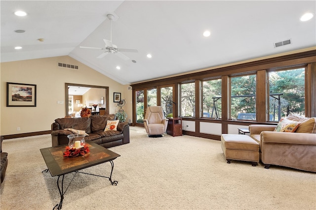 carpeted living room with ceiling fan and lofted ceiling