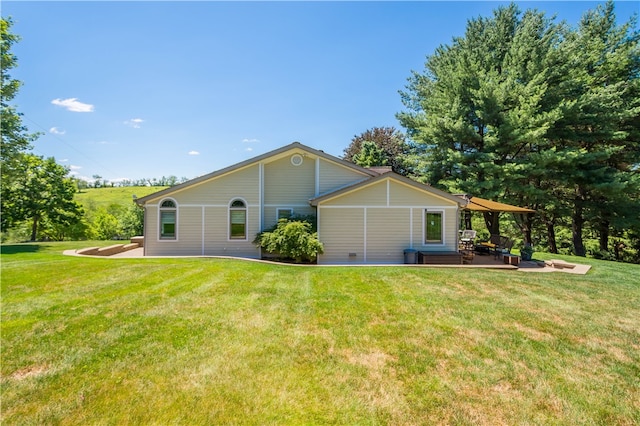 back of property with a yard and a patio area