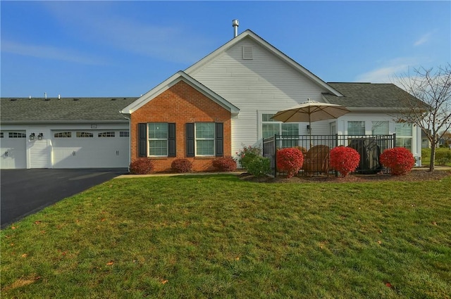 view of front of property with a front lawn and a garage