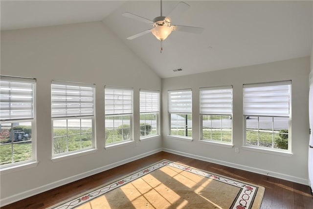 unfurnished sunroom featuring ceiling fan, lofted ceiling, and a wealth of natural light