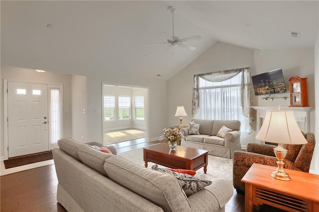 living room featuring ceiling fan, high vaulted ceiling, and dark hardwood / wood-style floors