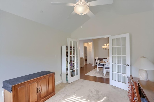 interior space featuring ceiling fan with notable chandelier, high vaulted ceiling, and french doors