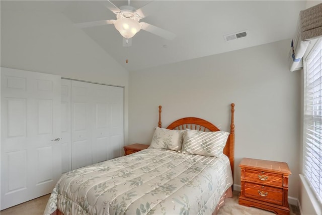 bedroom featuring light carpet, a closet, multiple windows, and ceiling fan