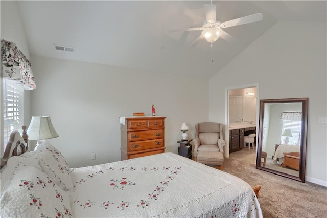 carpeted bedroom with connected bathroom, high vaulted ceiling, and ceiling fan