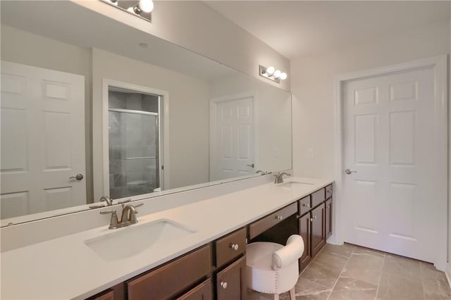 bathroom featuring vanity and an enclosed shower