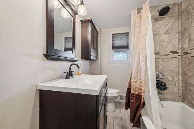 full bathroom with toilet, shower / bath combo, vanity, and hardwood / wood-style floors