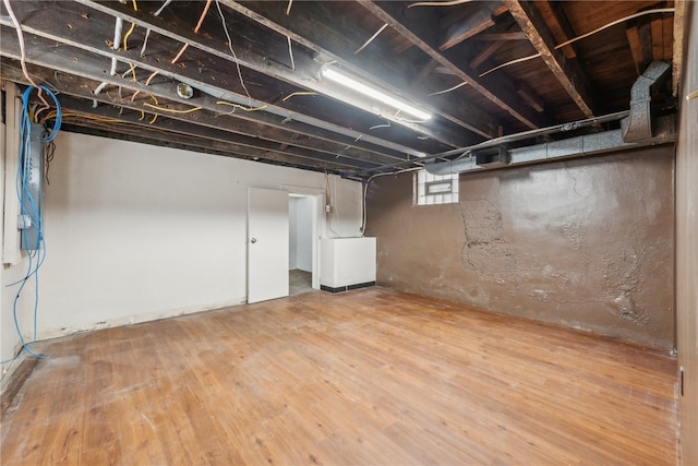 basement featuring wood-type flooring