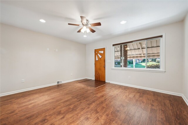 spare room featuring ceiling fan and dark hardwood / wood-style floors