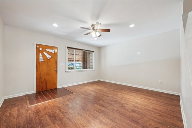 interior space with dark wood-type flooring and ceiling fan