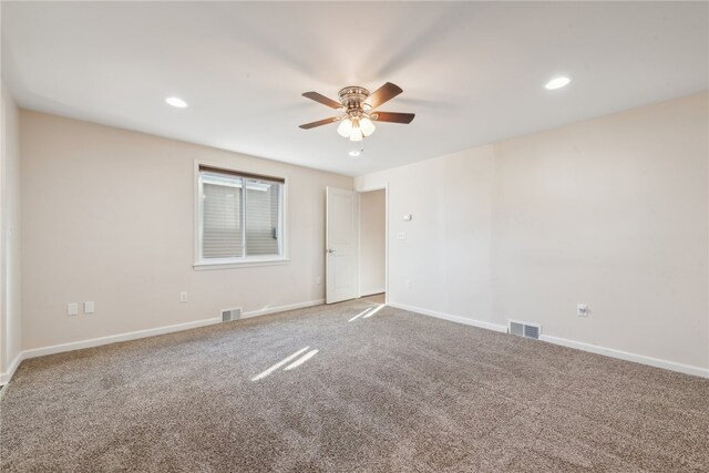 carpeted spare room with ceiling fan