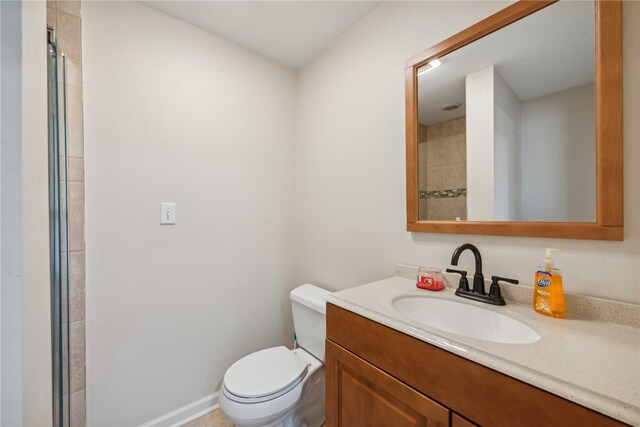 bathroom featuring walk in shower, vanity, and toilet