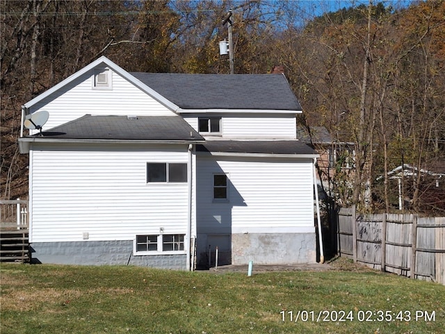 view of side of home with a yard