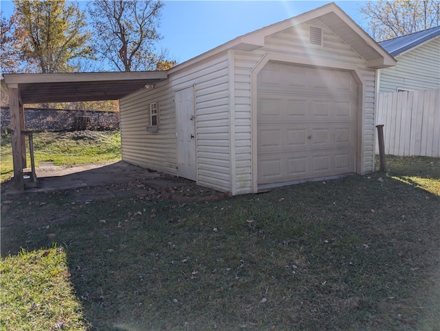 garage with a yard and a carport