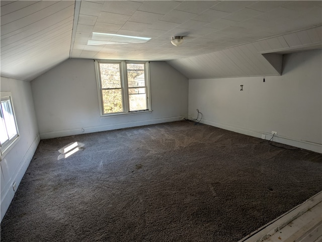 bonus room featuring a healthy amount of sunlight, vaulted ceiling, and carpet