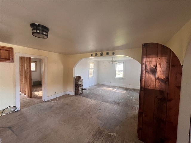 unfurnished living room with ceiling fan