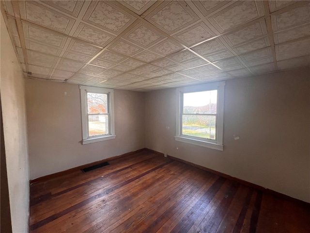 empty room with dark hardwood / wood-style flooring