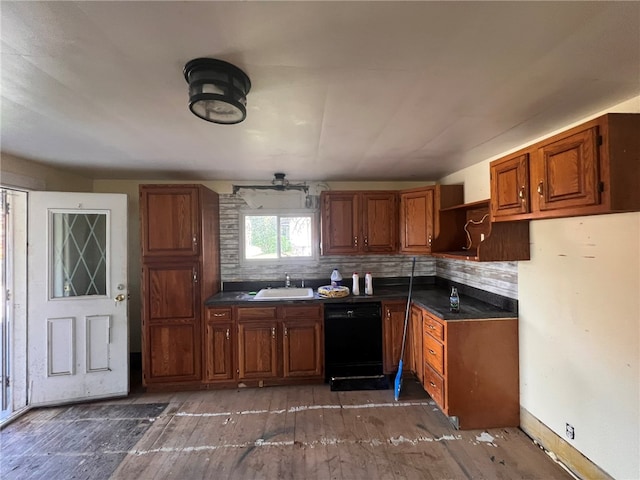 kitchen featuring dishwasher, backsplash, and sink