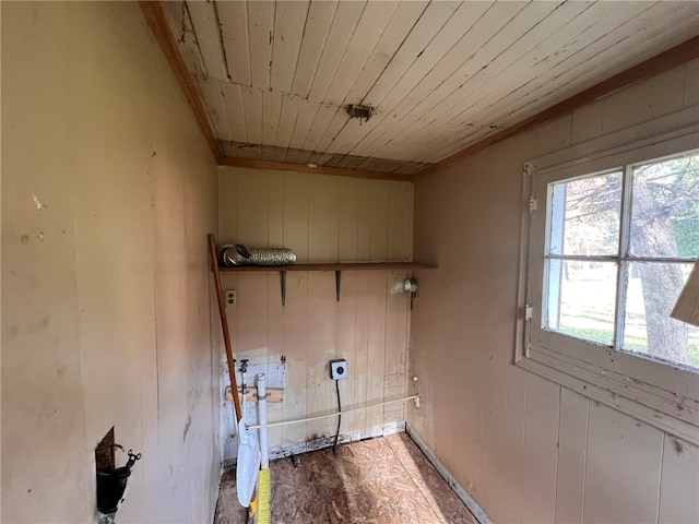 laundry room featuring electric dryer hookup, wooden walls, and wooden ceiling