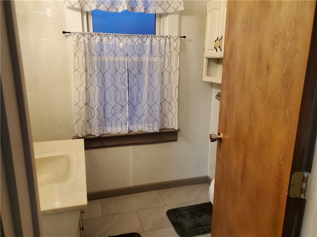 bathroom with tile patterned flooring, vanity, and toilet