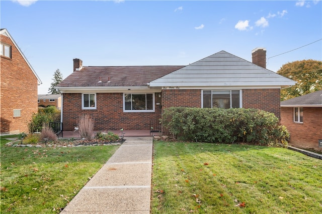 bungalow-style house featuring a front yard