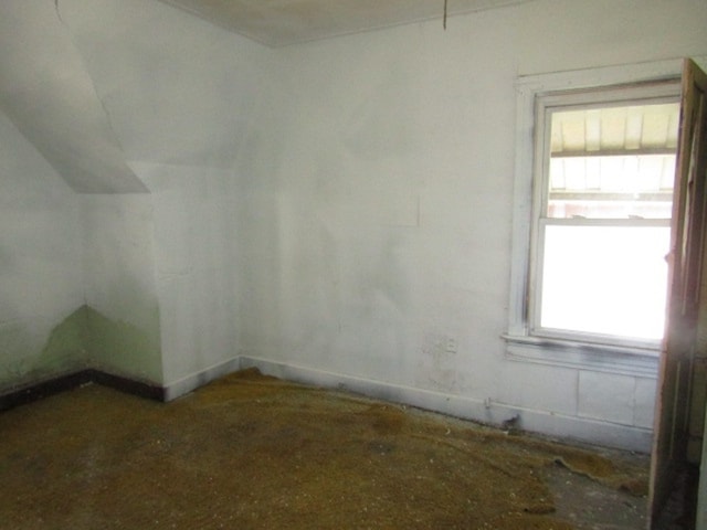 empty room featuring vaulted ceiling