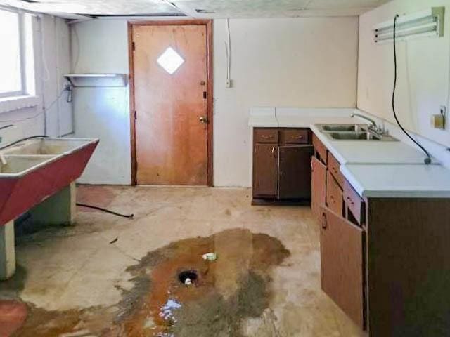 kitchen featuring light countertops and a sink