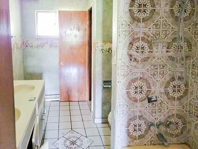 bathroom with tile patterned flooring and vanity