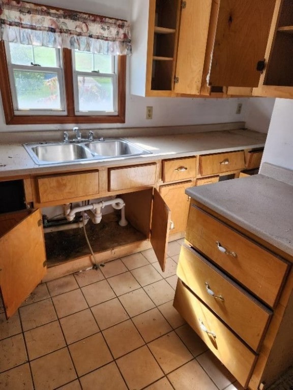 kitchen with light tile patterned floors and sink