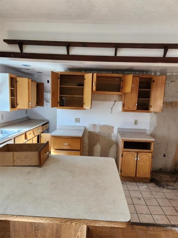 kitchen featuring sink and light tile patterned flooring