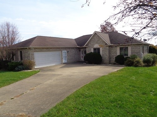 single story home with a front yard and a garage