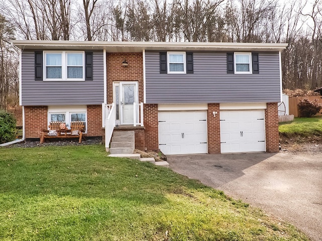 raised ranch with a garage and a front lawn