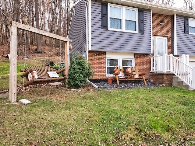 rear view of property with a lawn