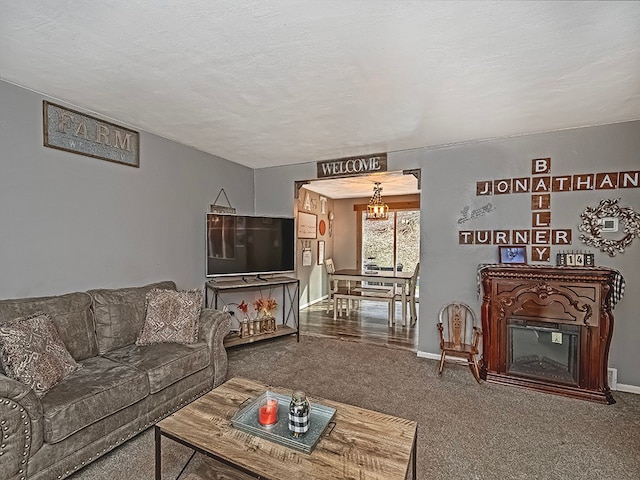 living room with carpet flooring, a textured ceiling, and a notable chandelier